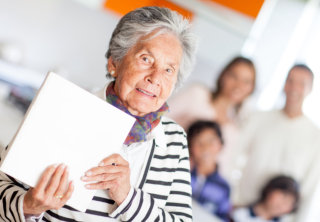 old woman holding a box