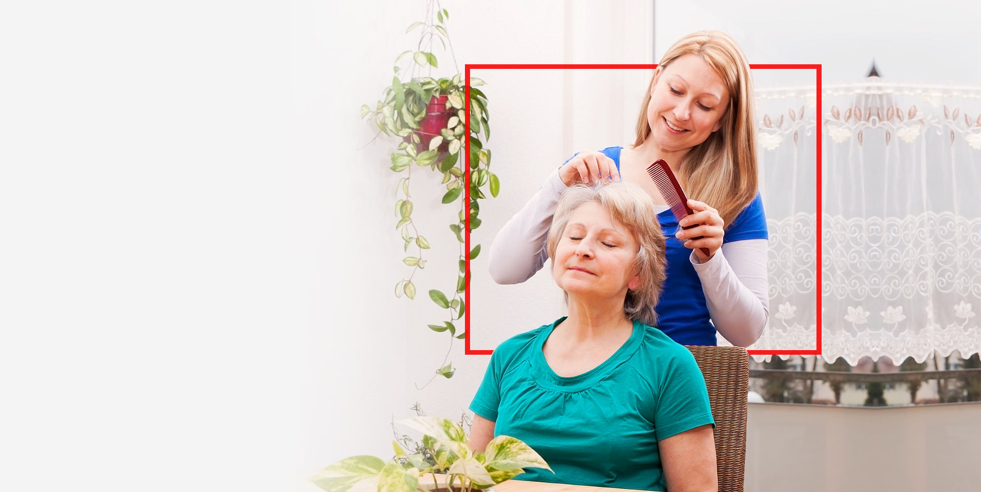 lady combing old woman's hair